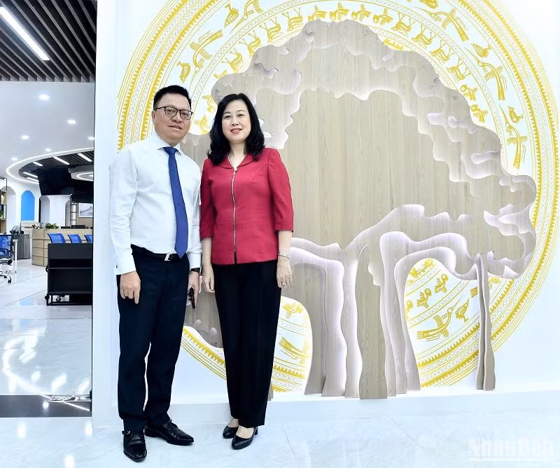 Tổng Biên tập Báo Nhân Dân, Chủ tịch Hội Nhà báo Việt Nam Lê Quốc Minh và Bộ trưởng Y tế Đào Hồng Lan chụp ảnh tại Tòa soạn hội tụ Nhân Dân điện tử. (Ảnh: ĐĂNG KHOA)