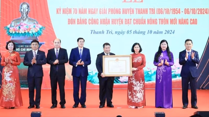 Phó Bí thư Thường trực Thành ủy Hà Nội Nguyễn Thị Tuyến trao Bằng công nhận huyện Thanh Trì đạt chuẩn nông thôn mới nâng cao cho lãnh đạo huyện Thanh Trì. (Ảnh: Quang Thái)