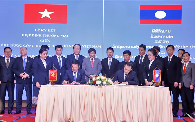 Lễ ký hiệp định thương mại giữa hai nước Việt Nam-Lào tại Viêng Chăn. (Ảnh TTXVN)