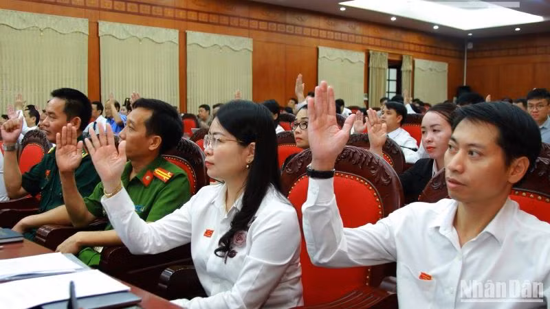 Các đại biểu Hội đồng nhân dân tỉnh Sơn La khóa 15 biểu quyết nhất trí thông qua các nghị quyết tại kỳ họp.