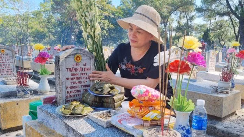Con gái thắp hương cho bố đang yên nghỉ tại Nghĩa trang liệt sĩ Trường Sơn.