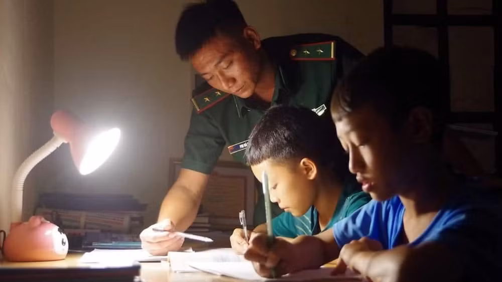 Những người "cha đỡ đầu" của Đồn Biên phòng Pa Ủ dạy các con học bài.