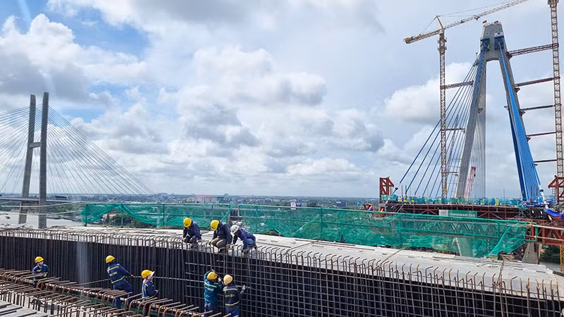 Công nhân lao động đang làm việc trên công trường, đoạn chuẩn bị nối nhịp chính của cây cầu. Công nhân lao động đang làm việc trên công trường, đoạn chuẩn bị nối nhịp chính của cây cầu.