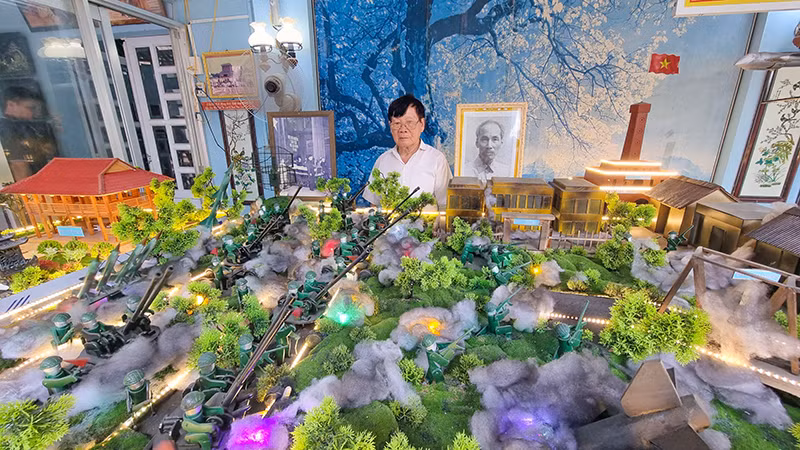 Ông 2 Minh bên mô hình sa bàn nhà mình.