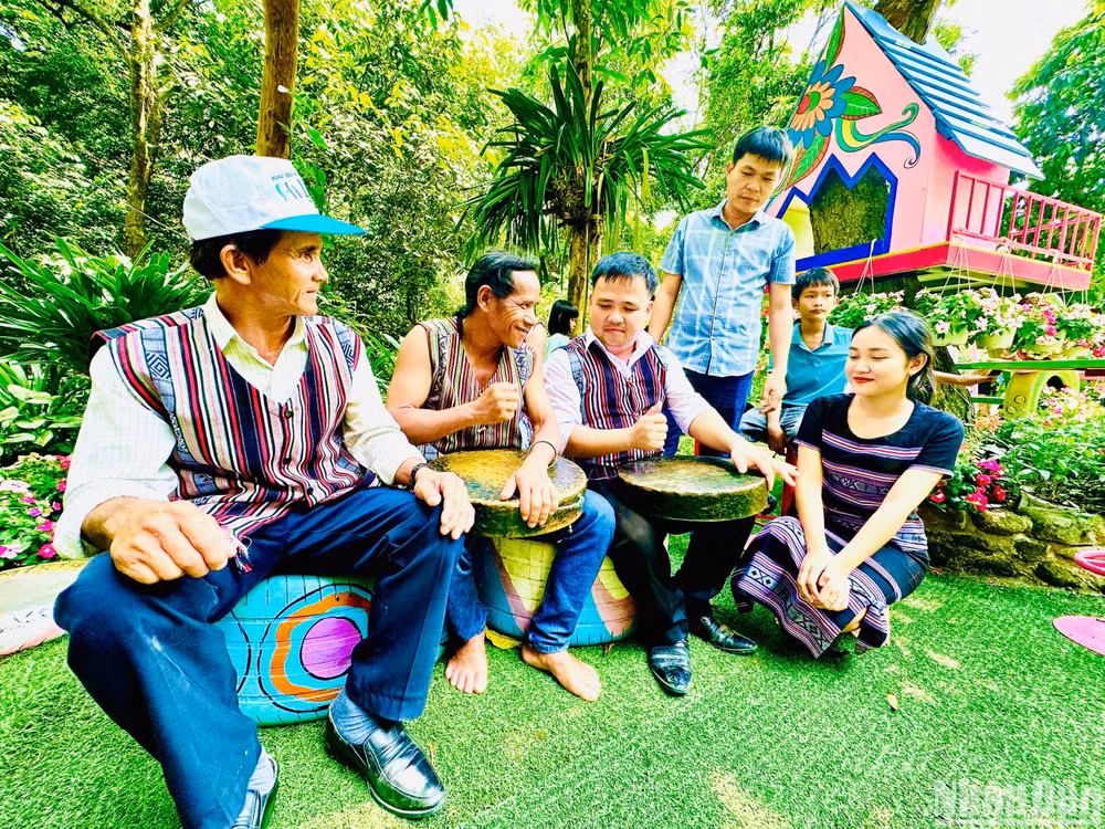 Du khách trải nghiệm đánh cồng chiêng cùng nghệ nhân Chiêng Ba. Du khách trải nghiệm đánh cồng chiêng cùng nghệ nhân Chiêng Ba.