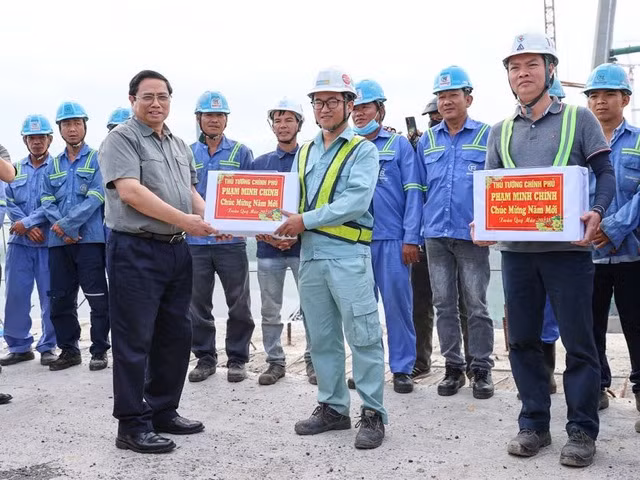 Thủ tướng Phạm Minh Chính tặng quà, động viên kỹ sư, công nhân trên công trường cầu Mỹ Thuận 2. (Ảnh: VGP/Nhật Bắc)