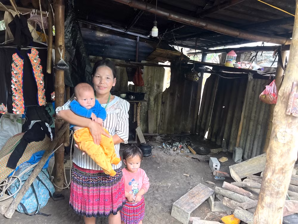 Chị Giàng Thị Lề đang bế đưa con thứ 12 mới được 4 tháng tuổi bên trong căn nhà cũ. (Ảnh: MINH PHƯƠNG) Chị Giàng Thị Lề đang bế đưa con thứ 12 mới được 4 tháng tuổi bên trong căn nhà cũ. (Ảnh: MINH PHƯƠNG)