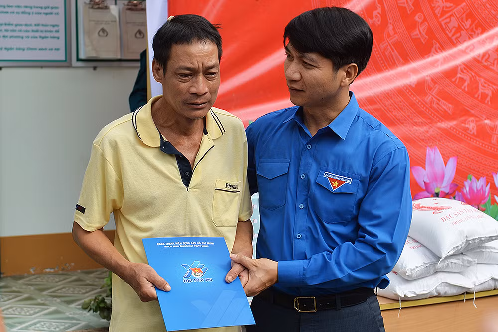 Đồng chí Nguyễn Ngọc Lương trao quà, động viên ông Cà Văn Luyến tại trụ sở Ủy ban nhân dân xã Mường Pồn.