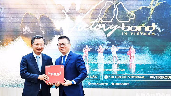 Tổng Biên tập Báo Nhân Dân Lê Quốc Minh (phải) trao tặng MV cho Phó Chủ tịch UBND tỉnh Quảng Ninh Cao Tường Huy.