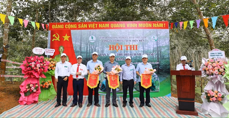 Các đồng chí lãnh đạo Công ty cổ phần cao-su Điện Biên trao cờ lưu niệm cho 3 nông trường có công nhân tham dự cuộc thi. Các đồng chí lãnh đạo Công ty cổ phần cao-su Điện Biên trao cờ lưu niệm cho 3 nông trường có công nhân tham dự cuộc thi.