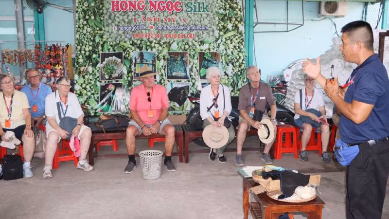 Du khách quốc tế tìm hiểu về nghề dệt lụa ở thị xã Tân Châu.