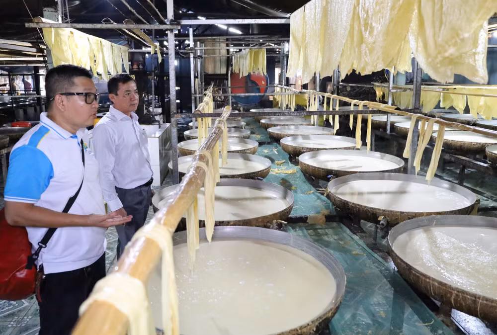 Người dân đang sản xuất tàu hũ ky tại làng nghề. (Ảnh: BÁ DŨNG) 