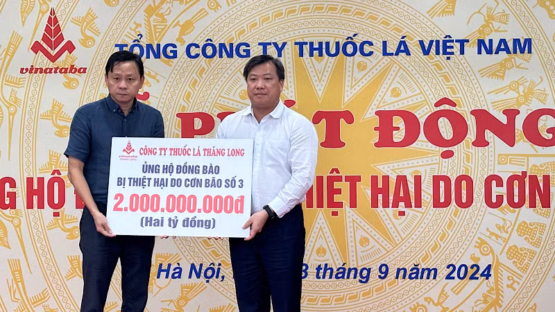 Chủ tịch Hội đồng thành viên Vinataba Hồ Lê Nghĩa nhận biển tượng trưng số tiền 2 tỷ đồng ủng hộ từ Chủ tịch Hội đồng thành viên Công ty thuốc lá Thăng Long Nguyễn Quang Huy.