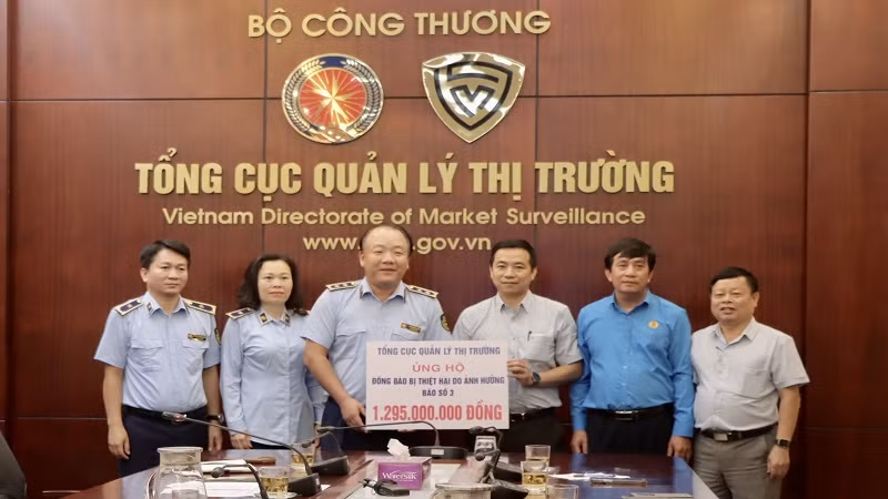 Tổng cục trưởng Quản lý thị trường Trần Hữu Linh trao biển tượng trưng số tiền gần 1,3 tỷ đồng cho Công đoàn Bộ Công thương để kịp thời ủng hộ đến người dân vùng lũ. 