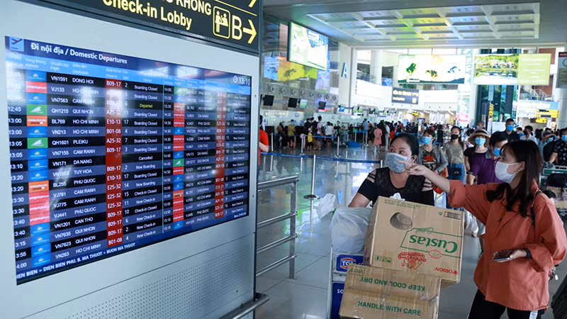 Hành khách theo dõi thông tin chuyến bay tại sân bay quốc tế Nội Bài, Hà Nội. ( Ảnh ĐĂNG ANH) Hành khách theo dõi thông tin chuyến bay tại sân bay quốc tế Nội Bài, Hà Nội. ( Ảnh ĐĂNG ANH)