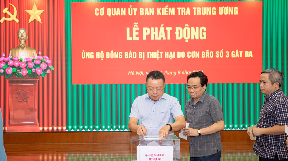 Các đồng chí lãnh đạo Ủy ban Kiểm tra Trung ương tham gia chia sẻ khó khăn với đồng bào bị thiệt hại do cơn bão số 3. (Ảnh: Sơn Tùng)
