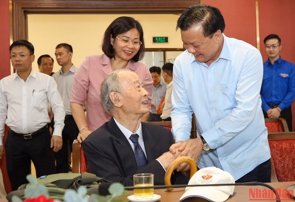 Bí thư Thành ủy Đinh Tiến Dũng thăm hỏi các đồng chí cán bộ lão thành cách mạng. (Ảnh: DUY LINH)