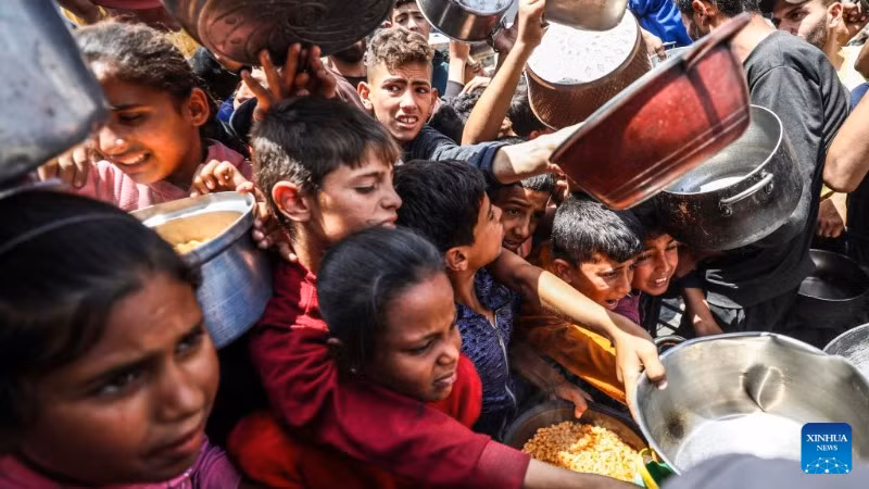 Người dân Palestine nhận thực phẩm miễn phí từ một trung tâm phân phối thực phẩm ở thành phố Gaza, ngày 3/5/2025. (Ảnh: Xinhua) 
