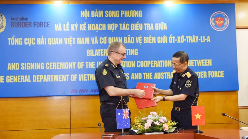 Tổng cục trưởng Tổng cục Hải quan Nguyễn Văn Cẩn và Cao ủy Cơ quan Bảo vệ biên giới Australia Michael Outram ký kế hoạch hợp tác điều tra. (Ảnh: TRUNG HƯNG)