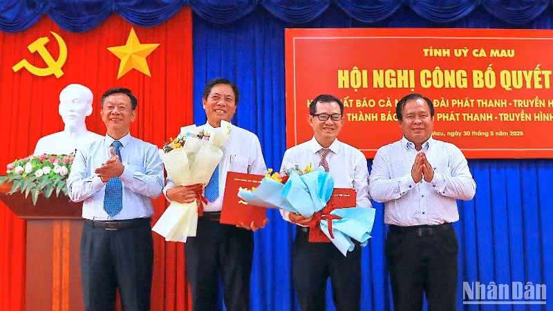 Đại diện lãnh đạo Tỉnh ủy và Ủy ban nhân dân tỉnh Cà Mau trao quyết định và tặng hoa chúc mừng nhà báo Ngô Minh Toàn và Phạm Thanh Phong (đứng giữa).