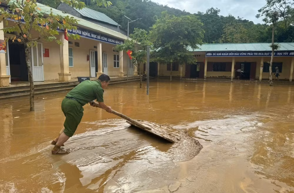 Lực lượng Công an giúp Trường phổ thông dân tộc bán trú tiểu học Lượng Minh ở bản Minh Tiến dọn dẹp bùn đất trong sáng 1/10.
