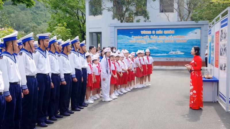 Chiến sĩ trẻ và các em học sinh nghe giới thiệu về Vùng 3 Hải quân.
