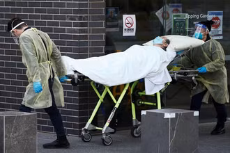 Nhân viên y tế đưa người bệnh rời khỏi nhà dưỡng lão tại Melbourne lên xe cấp cứu. (Ảnh: Reuters)