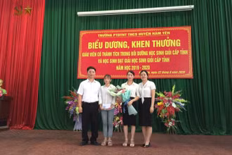 Lê Vân Anh trong vòng tay yêu thương của thầy, cô nhà trường. (Ảnh do BGH Trường THCS nội trú Hàm Yên cung cấp)