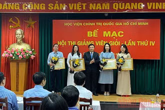 Đồng chí Nguyễn Xuân Thắng trao Bằng khen cho bốn giảng viên đạt danh hiệu Giảng viên xuất sắc. Ảnh: TRỊNH DŨNG