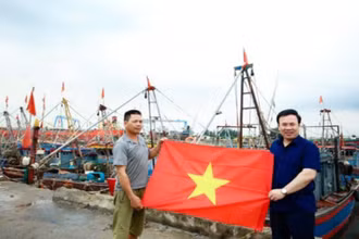 Ngư dân Nguyễn Văn Hà, trú tại đội 1, thị trấn Diêm Điền (huyện Thái Thụy, tỉnh Thái Bình) nhận cờ Tổ quốc tại cảng cá Diêm Điền.