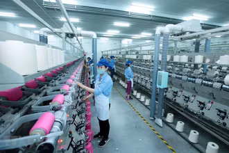 Công nhân sản xuất sản phẩm dệt nhuộm tại Công ty TNHH Dệt nhuộm Jasan Việt Nam. Ảnh: Phạm Kiên/TTXVN