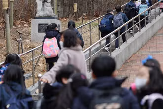 Học sinh tiểu học ở Seoul đến trường trong sáng 14/3/2022. (Ảnh: Yonhap)