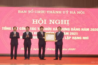 Đồng chí Vương Đình Huệ, Ủy viên Bộ Chính trị, Bí thư Thành ủy Hà Nội trao Huân chương Độc lập hạng Nhì cho Ban Tổ chức Thành ủy Hà Nội. (Ảnh: Duy Linh)