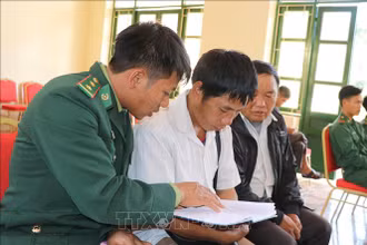 Chiến sĩ Đồn biên phòng Nậm Kè (Bộ đội Biên phòng tỉnh Điện Biên) trao đổi nội dung tuyên truyền, phổ biến pháp luật cho các trưởng bản. Ảnh: TTXVN.