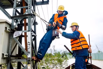 Công nhân điện lực Cẩm Lệ khắc phục sự cố ngay trong mưa bão.