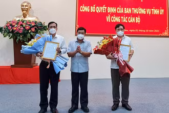 Bí thư Tỉnh ủy Cà Mau (giữa) tặng hoa chúc mừng hai cán bộ chủ chốt của tỉnh vừa được điều động. 
