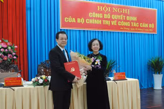 Đồng chí Trương Thị Mai trao quyết định, tặng hoa chúc mừng tân Bí thư Tỉnh ủy An Giang Lê Hồng Quang.