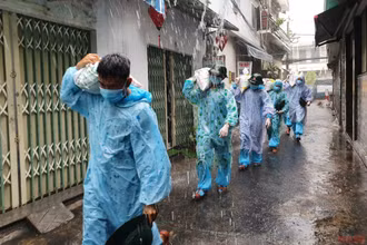 Hàng chục cán bộ chiến sĩ Trung đoàn 971 đội mưa vận chuyển cát gia cố nhà cho dân vùng phong tỏa cứng.