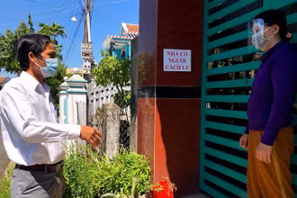 Thành viên Tổ Covid cộng đồng ở huyện Mộ Đức (Quảng Ngãi) nhắc nhở gia đình có người cách ly tại nhà thực hiện nghiêm quy định phòng, chống dịch. 