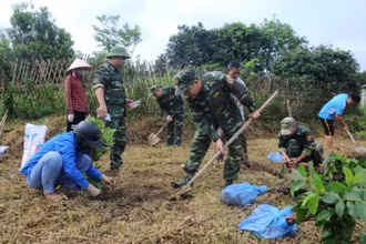 Cán bộ, chiến sĩ Đồn Biên phòng Pò Hèn giúp người dân thôn Lục Chắn xây dựng vườn mẫu.