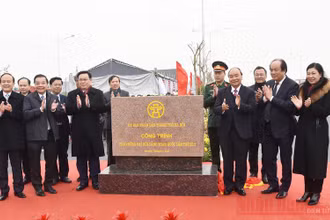 Thủ tướng Nguyễn Xuân Phúc cùng lãnh đạo TP Hà Nội, các bộ, ngành thực hiện nghi thức gắn biển "Công trình chào mừng Đại hội Đảng toàn quốc lần thứ XIII". (Ảnh: TRẦN HẢI)