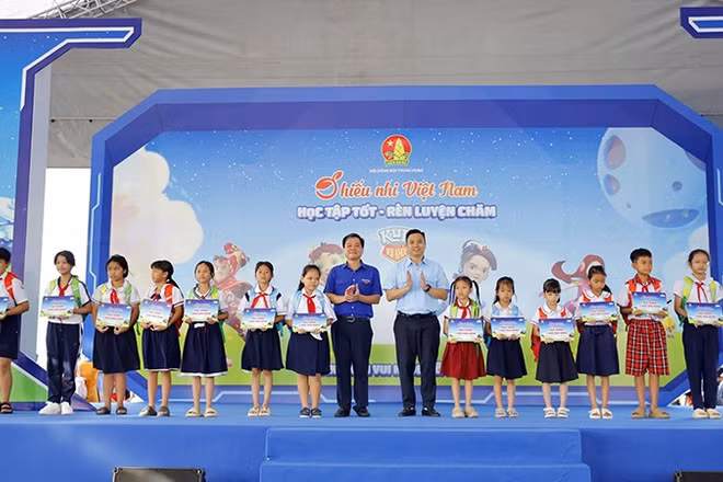 Ban tổ chức trao học bổng tặng học sinh vượt khó học tốt tại ngày hội.