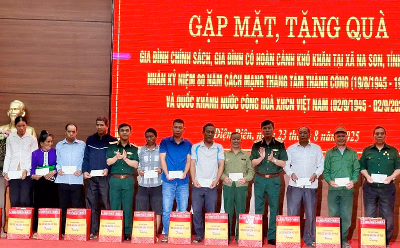 Các đồng chí trong Đoàn công tác Tổng cục Hậu cần-Kỹ thuật Bộ Quốc phòng trao quà tặng các gia đình chính sách, hộ nghèo ở xã Na Son. 