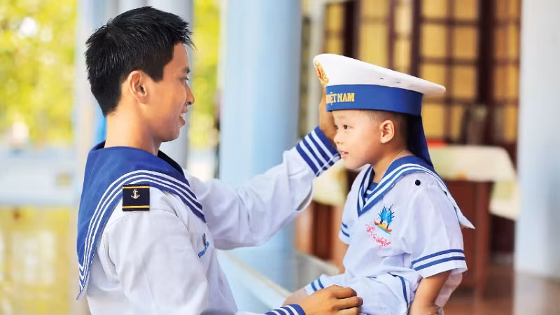Chiến sĩ hải quân cùng em nhỏ trên đặc khu Trường Sa. (Ảnh: THẾ ĐẠI)