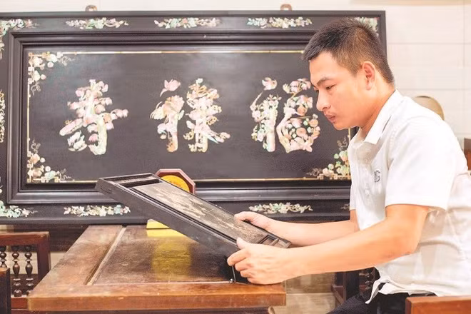 Nghệ nhân trẻ Phan Tấn Đạt bên một sản phẩm khảm ốc.