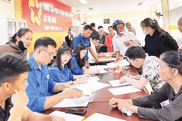 Thanh niên xung kích xã Thọ Xuân hỗ trợ người dân đăng ký mở tài khoản an sinh.