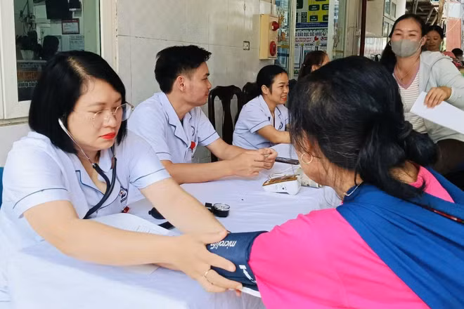 Các y, bác sĩ khám bệnh cho người dân xã Than Uyên. (Ảnh: TRẦN TUẤN)