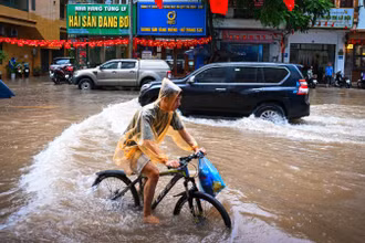 [Ảnh] Nhiều tuyến phố Hà Nội ngập sâu, xe đạp thành phương tiện "ưu việt"