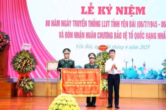 Đồng chí Bí thư Tỉnh ủy Yên Bái Trần Huy Tuấn trao cờ thêu cho Lực lượng vũ trang tỉnh. 