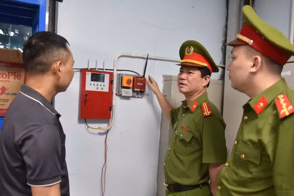Cảnh sát Phòng cháy, chữa cháy và cứu nạn, cứu hộ hướng dẫn người dân sử dụng thiết bị báo cháy. (Ảnh: C07)